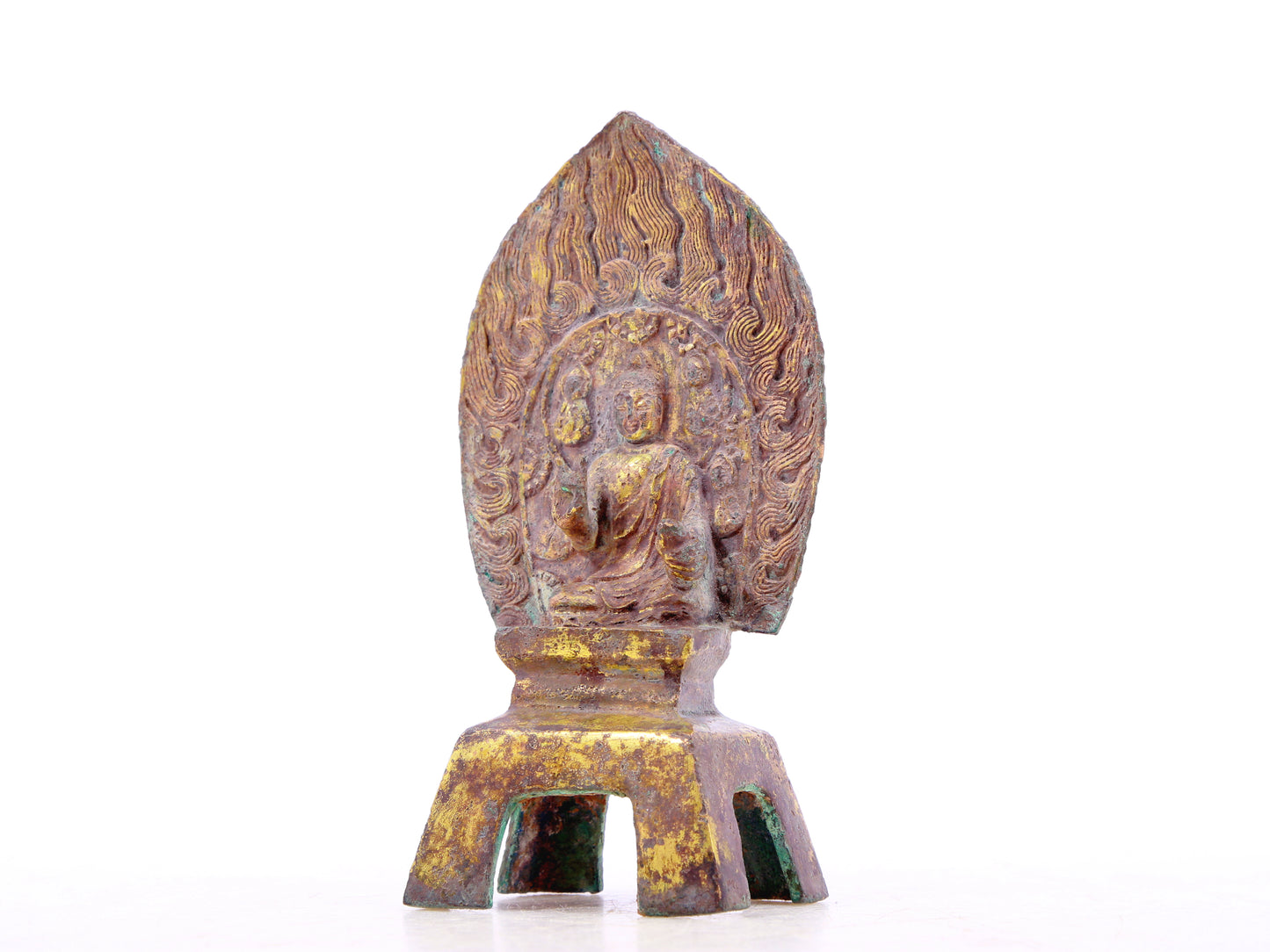 A serene gilt bronze statue of Gautama Buddha