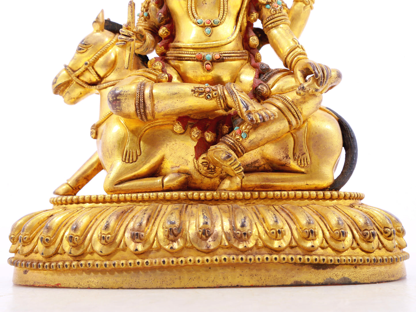 A serene gilt bronze statue of the Heavenly King inlaid with precious stones