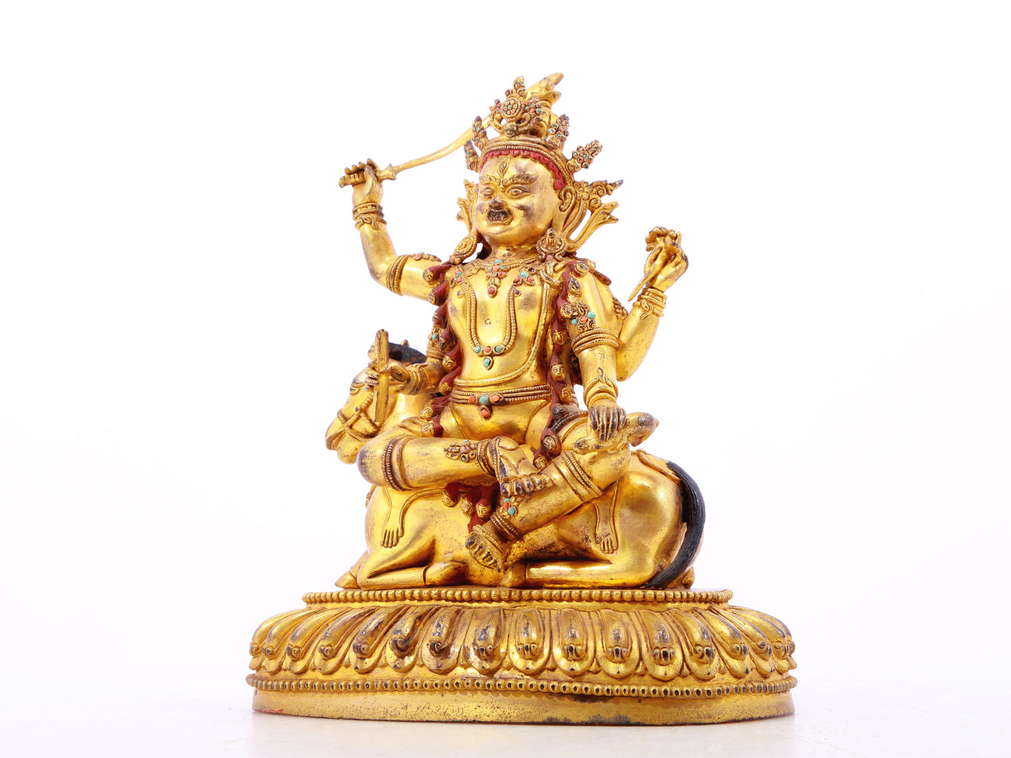 A serene gilt bronze statue of the Heavenly King inlaid with precious stones