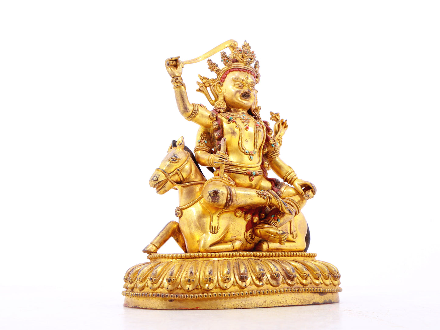 A serene gilt bronze statue of the Heavenly King inlaid with precious stones