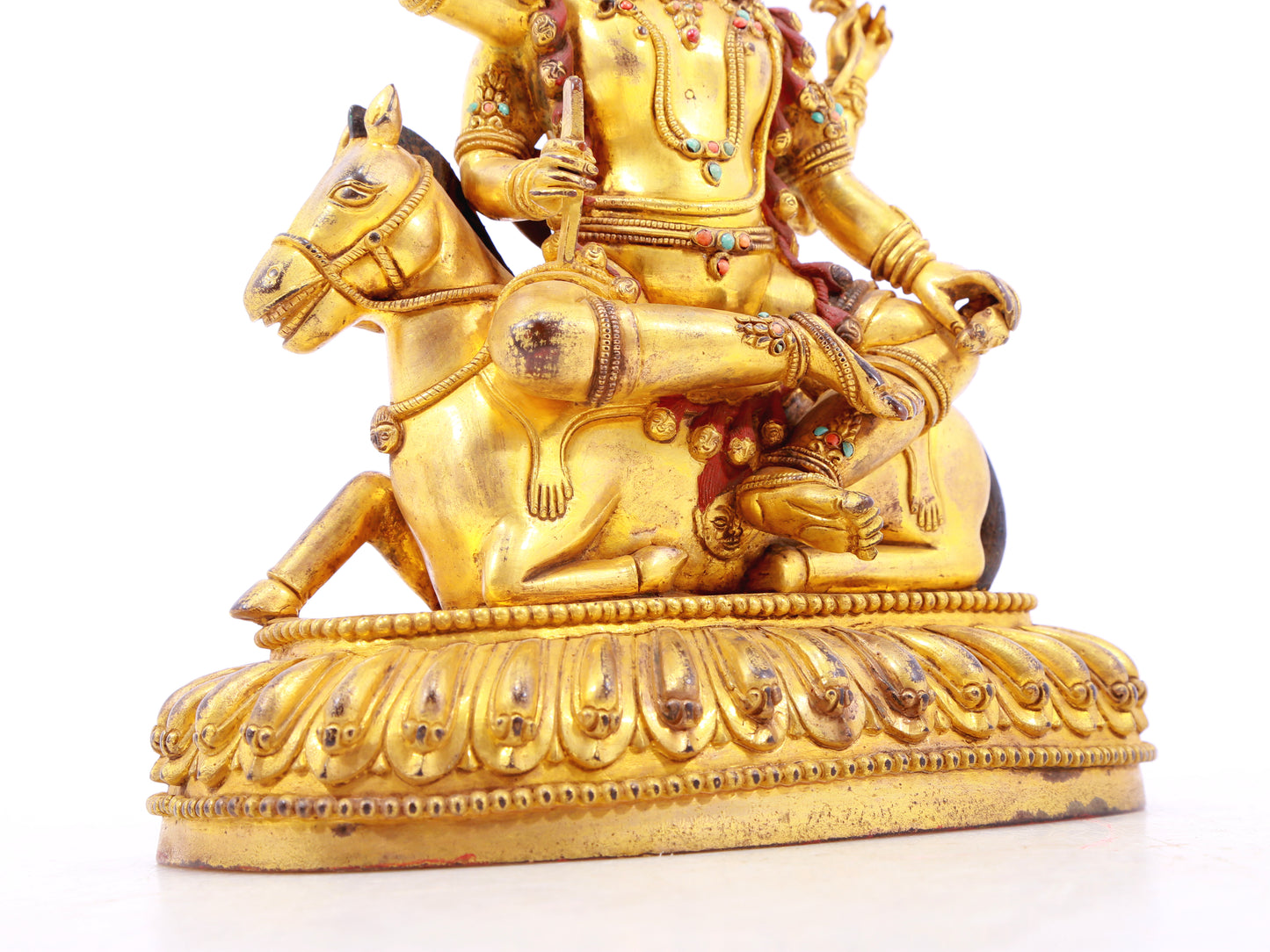 A serene gilt bronze statue of the Heavenly King inlaid with precious stones