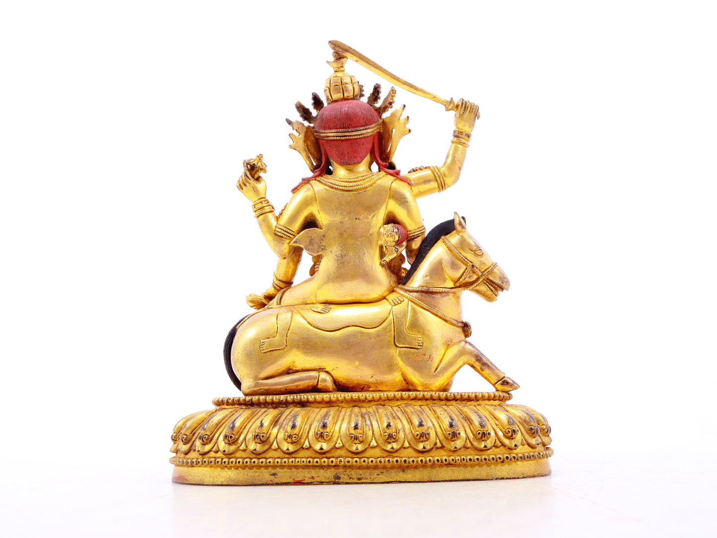 A serene gilt bronze statue of the Heavenly King inlaid with precious stones