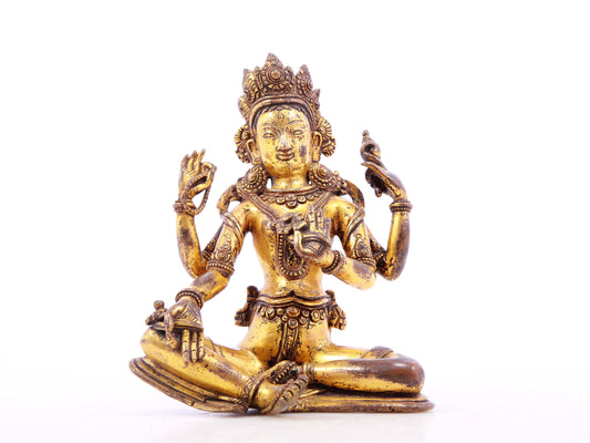 A solemn gilt bronze four-armed Guanyin statue