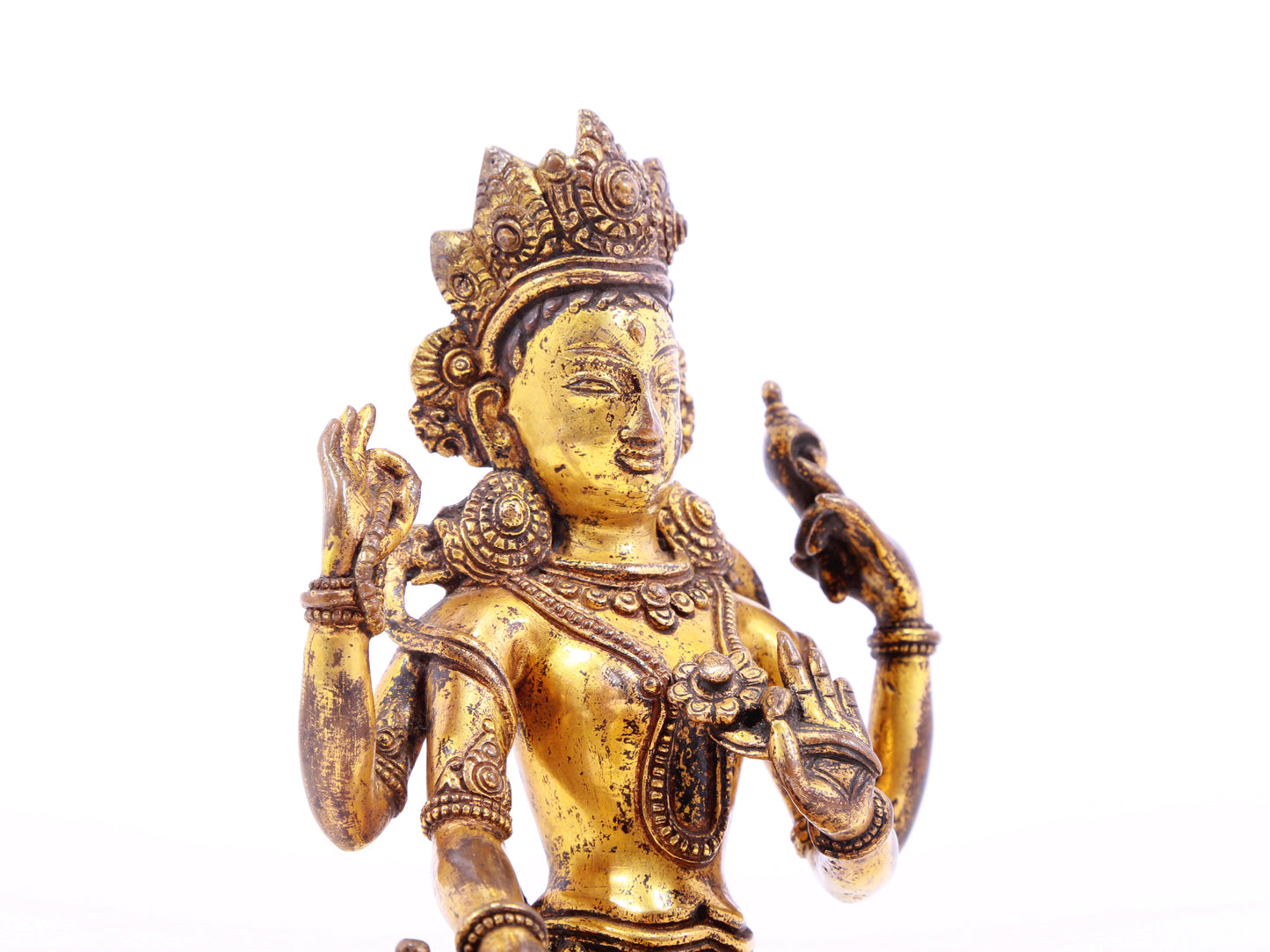 A solemn gilt bronze four-armed Guanyin statue