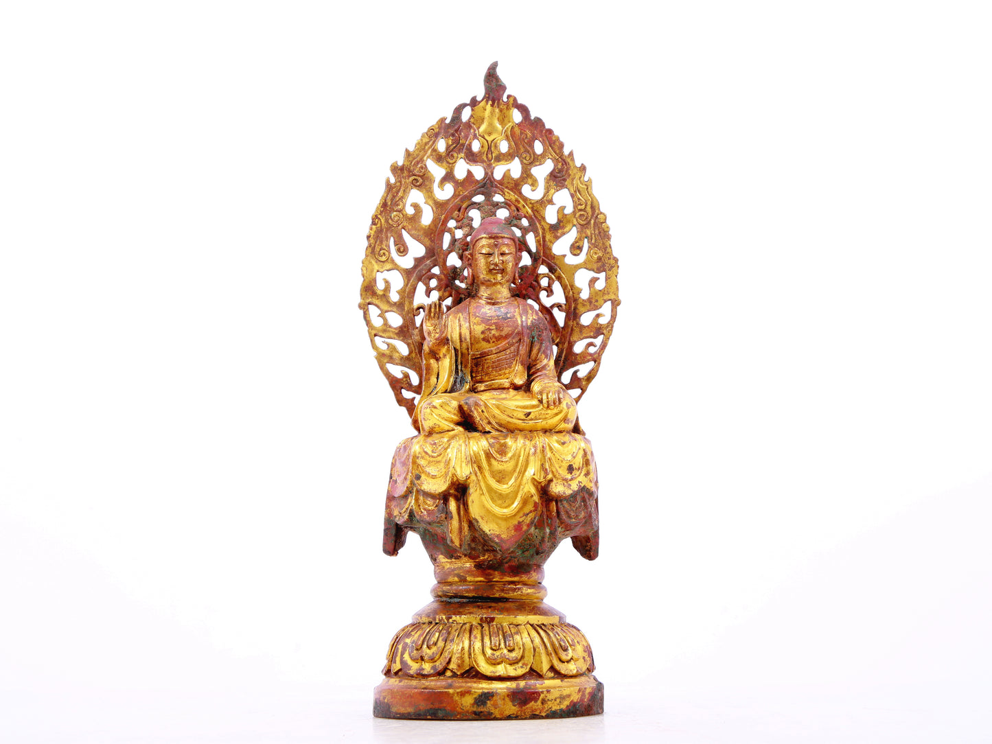 A serene gilt bronze statue of Gautama Buddha