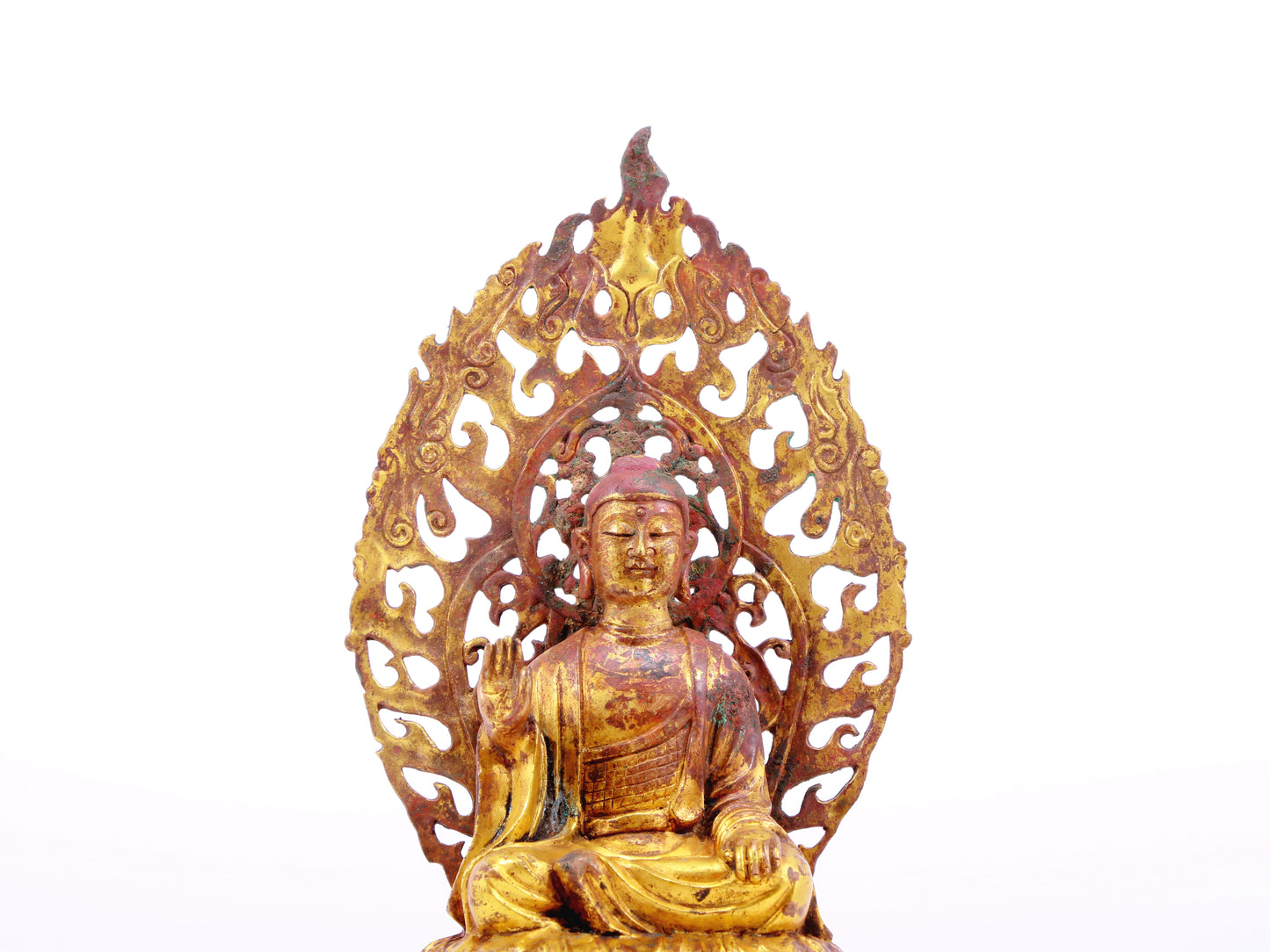 A serene gilt bronze statue of Gautama Buddha