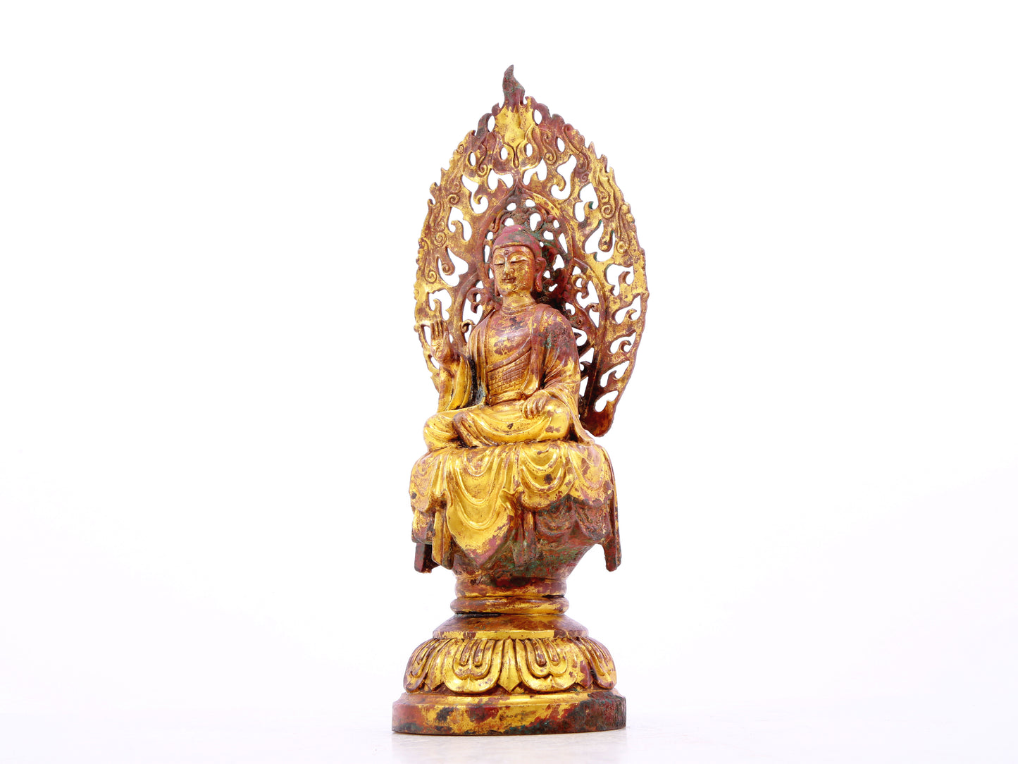 A serene gilt bronze statue of Gautama Buddha