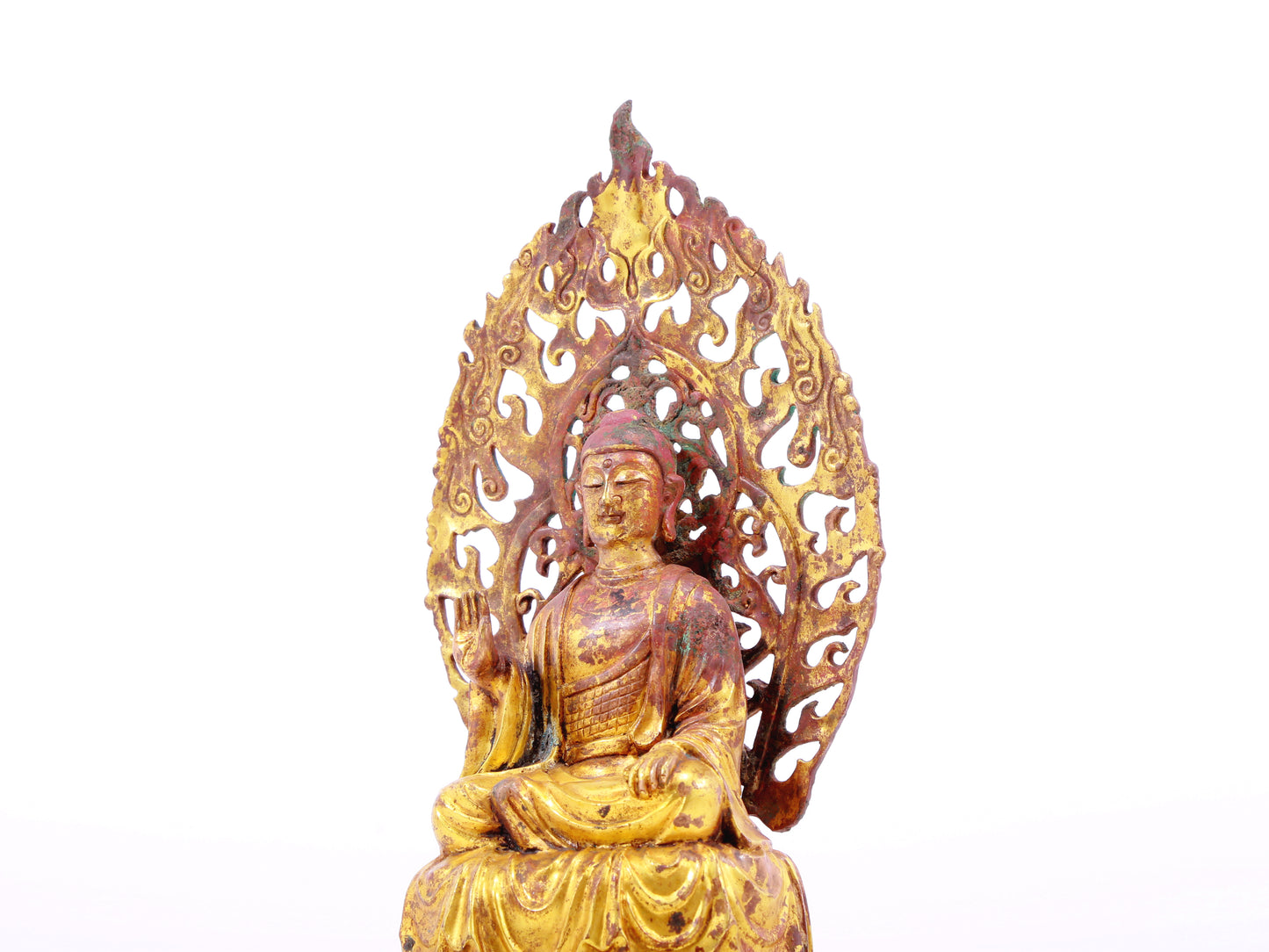 A serene gilt bronze statue of Gautama Buddha