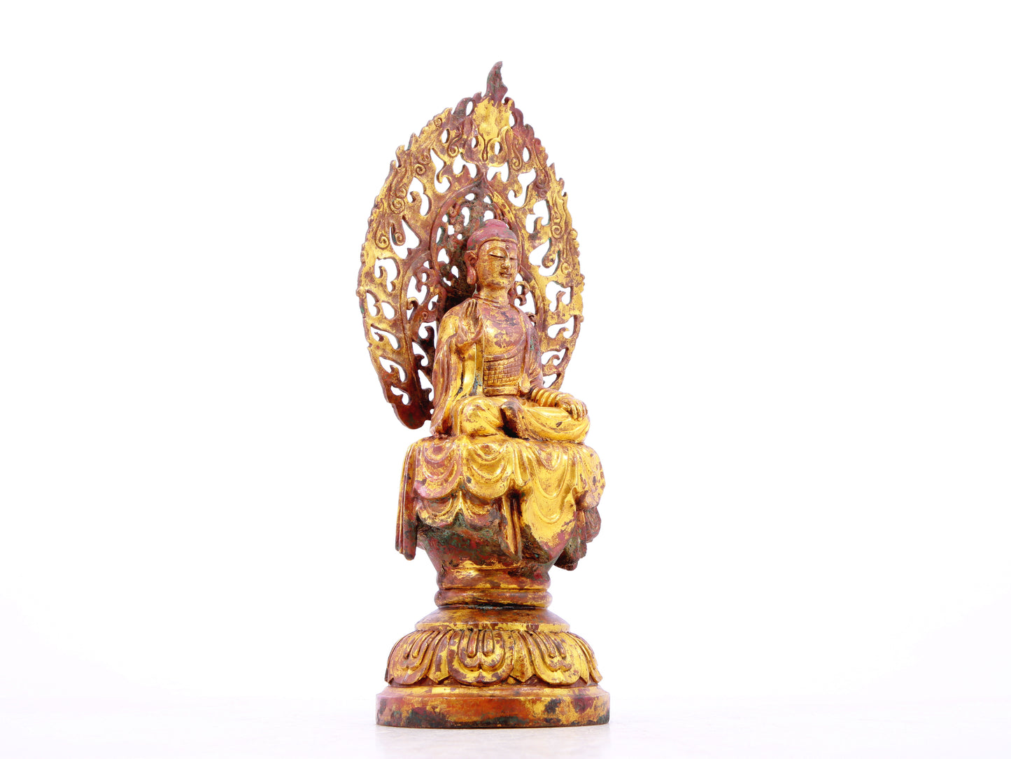 A serene gilt bronze statue of Gautama Buddha