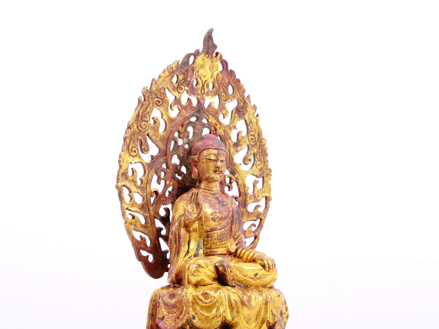 A serene gilt bronze statue of Gautama Buddha