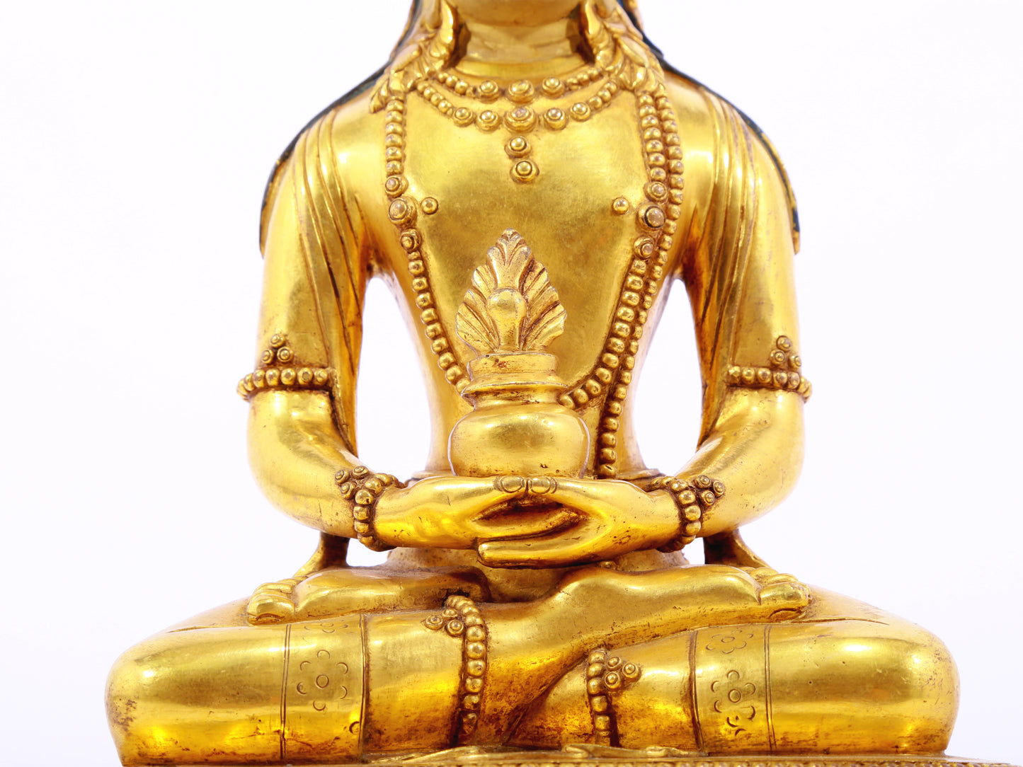 A serene gilt bronze statue of Amitayus Buddha