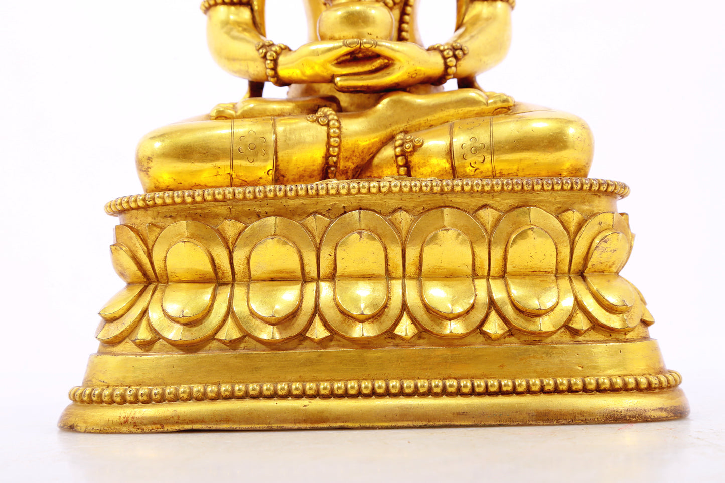 A serene gilt bronze statue of Amitayus Buddha