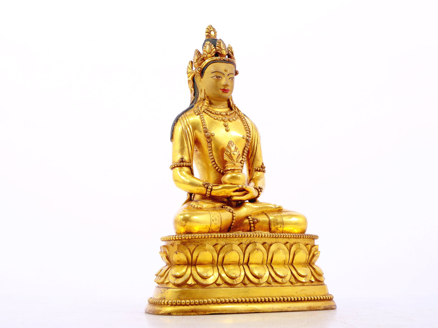 A serene gilt bronze statue of Amitayus Buddha