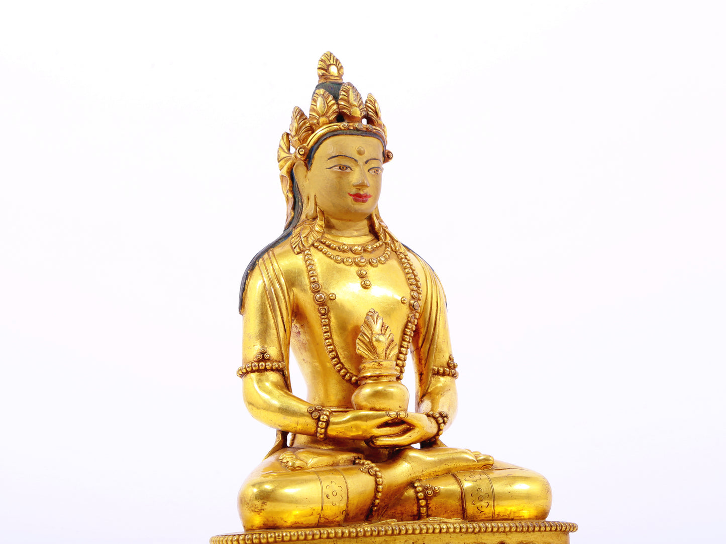 A serene gilt bronze statue of Amitayus Buddha