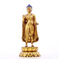 A serene gilt bronze statue of Gautama Buddha