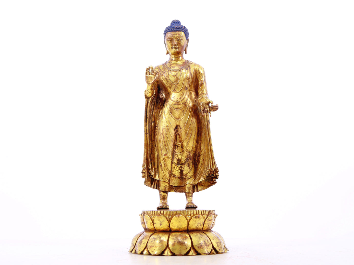 A serene gilt bronze statue of Gautama Buddha