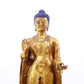 A serene gilt bronze statue of Gautama Buddha