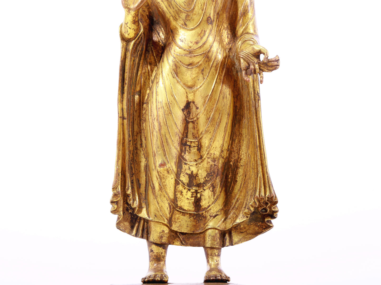 A serene gilt bronze statue of Gautama Buddha