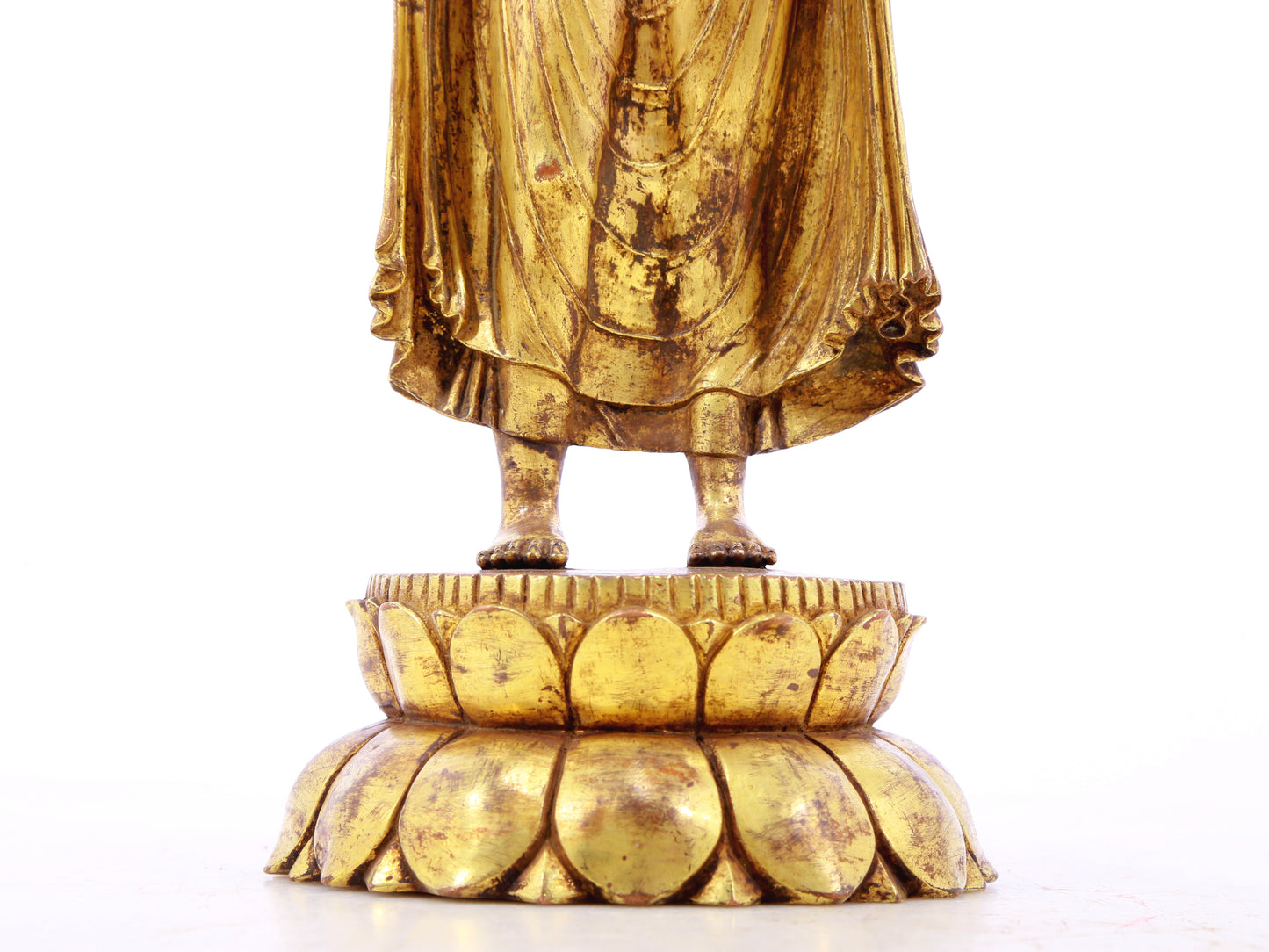 A serene gilt bronze statue of Gautama Buddha