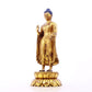 A serene gilt bronze statue of Gautama Buddha