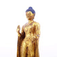 A serene gilt bronze statue of Gautama Buddha