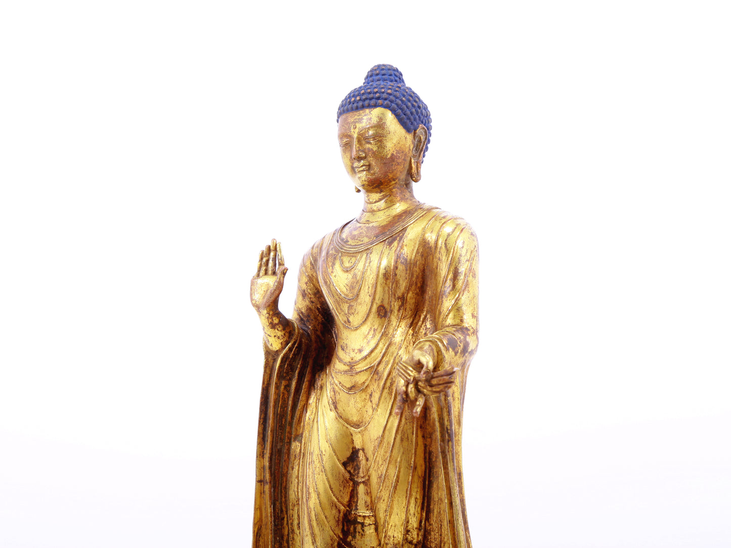 A serene gilt bronze statue of Gautama Buddha