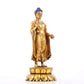 A serene gilt bronze statue of Gautama Buddha