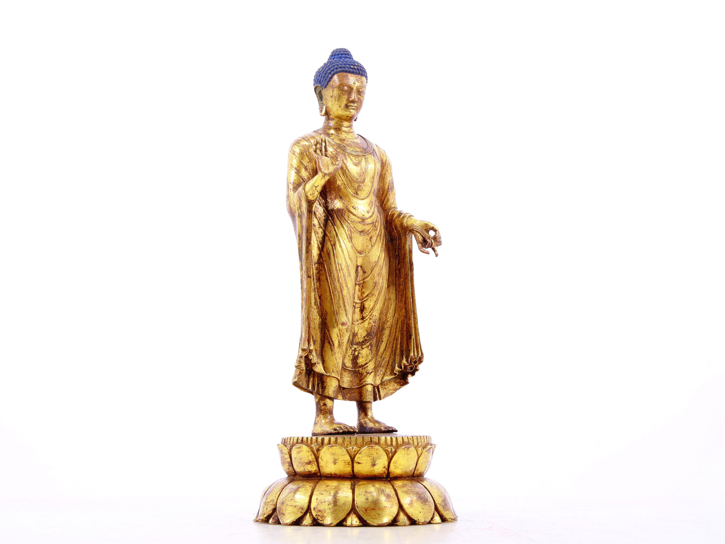 A serene gilt bronze statue of Gautama Buddha