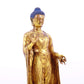 A serene gilt bronze statue of Gautama Buddha