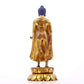 A serene gilt bronze statue of Gautama Buddha