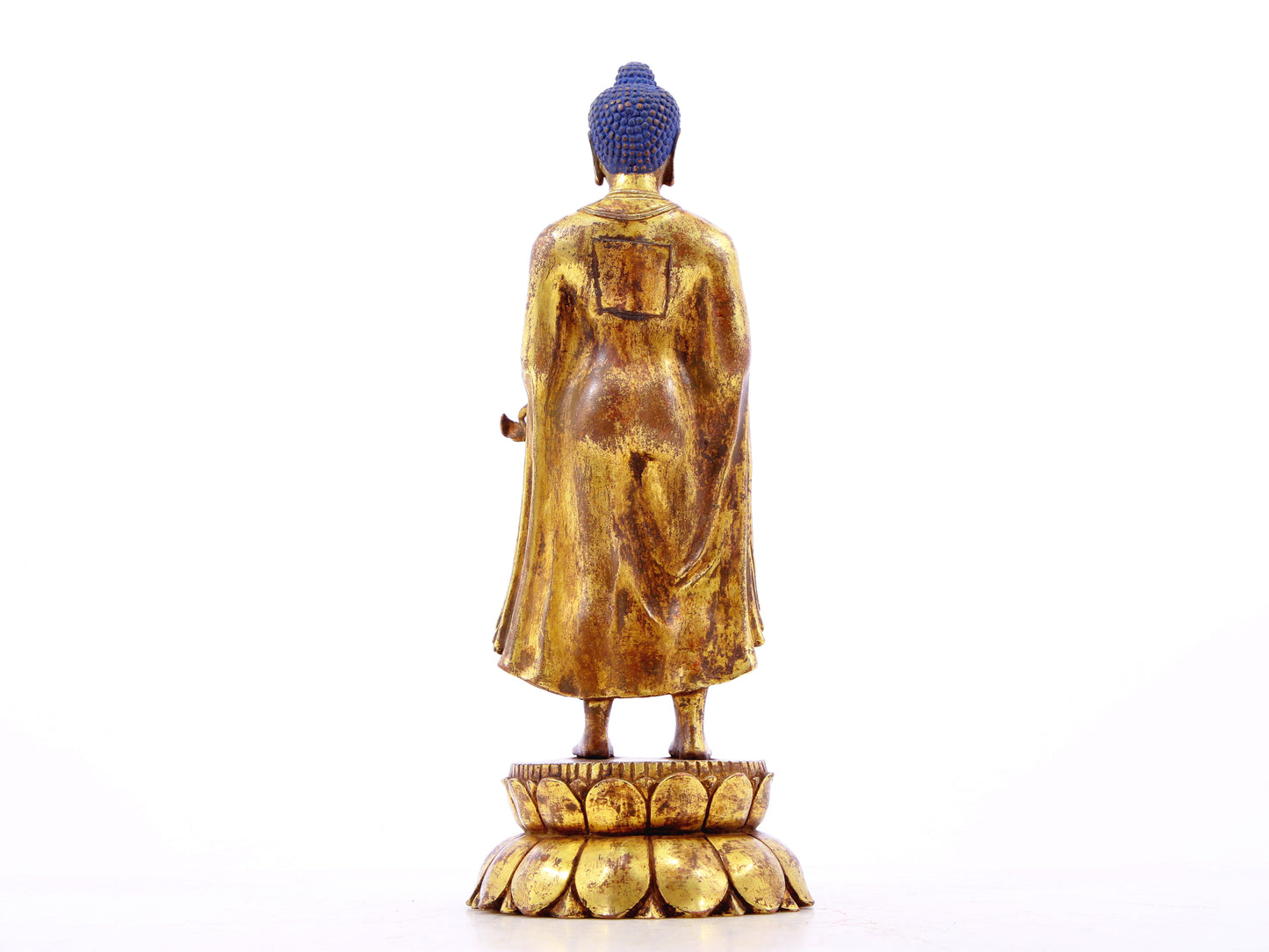 A serene gilt bronze statue of Gautama Buddha