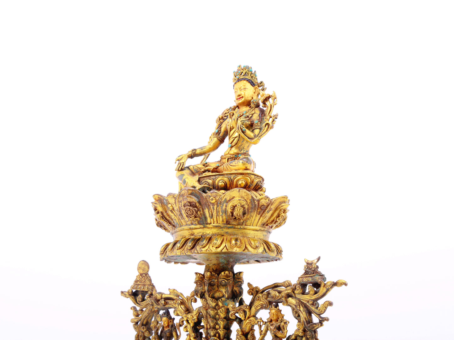 A serene gilt bronze statue of Tara inlaid with turquoise green