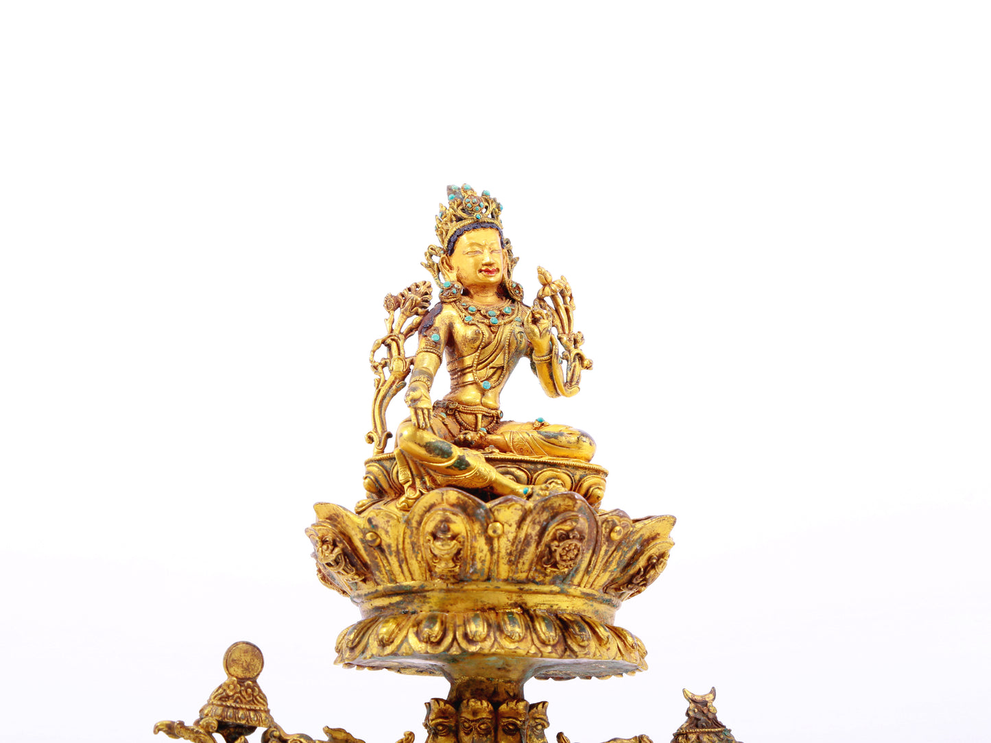 A serene gilt bronze statue of Tara inlaid with turquoise green