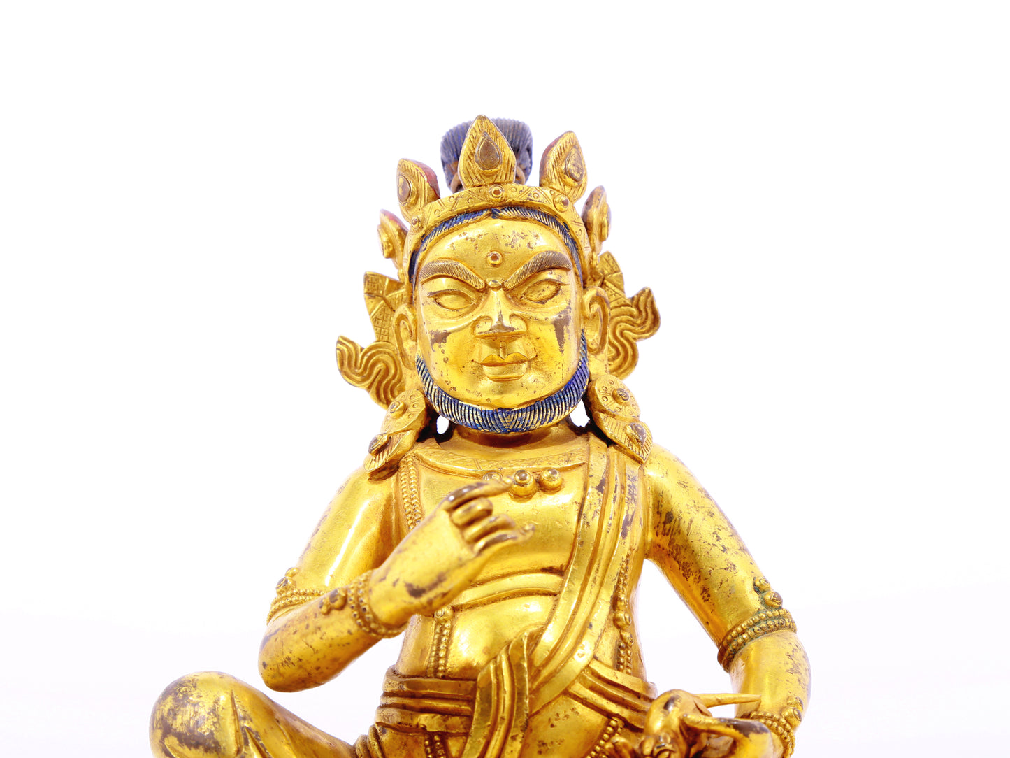 A serene gilt bronze statue of the God of Wealth