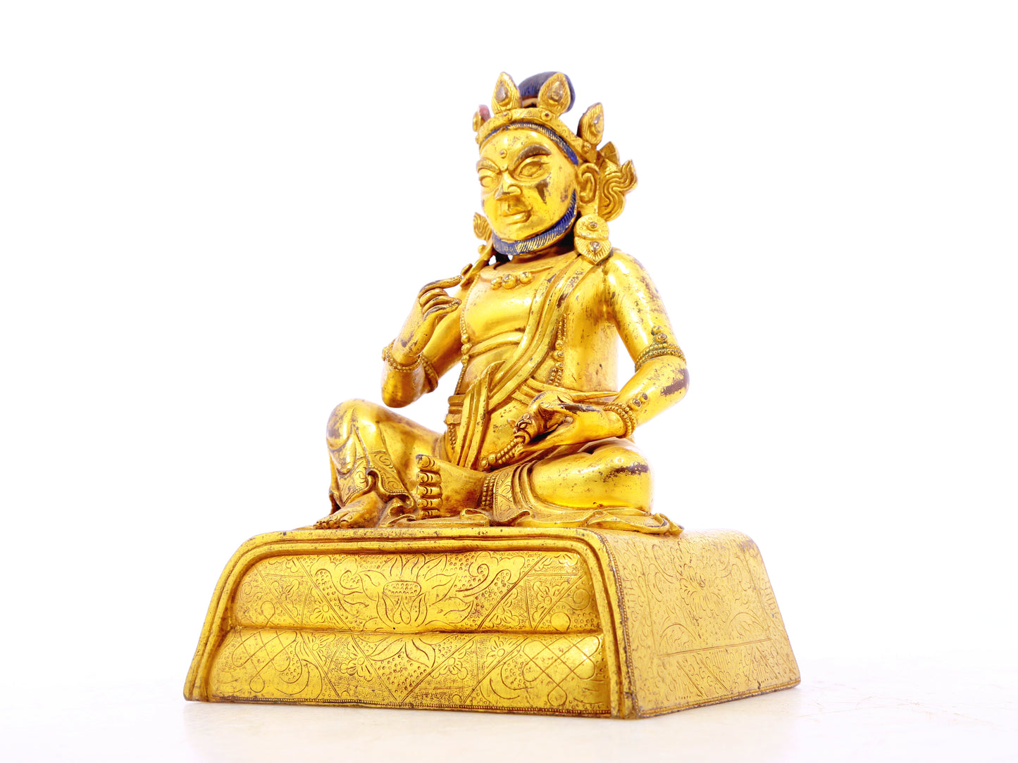 A serene gilt bronze statue of the God of Wealth