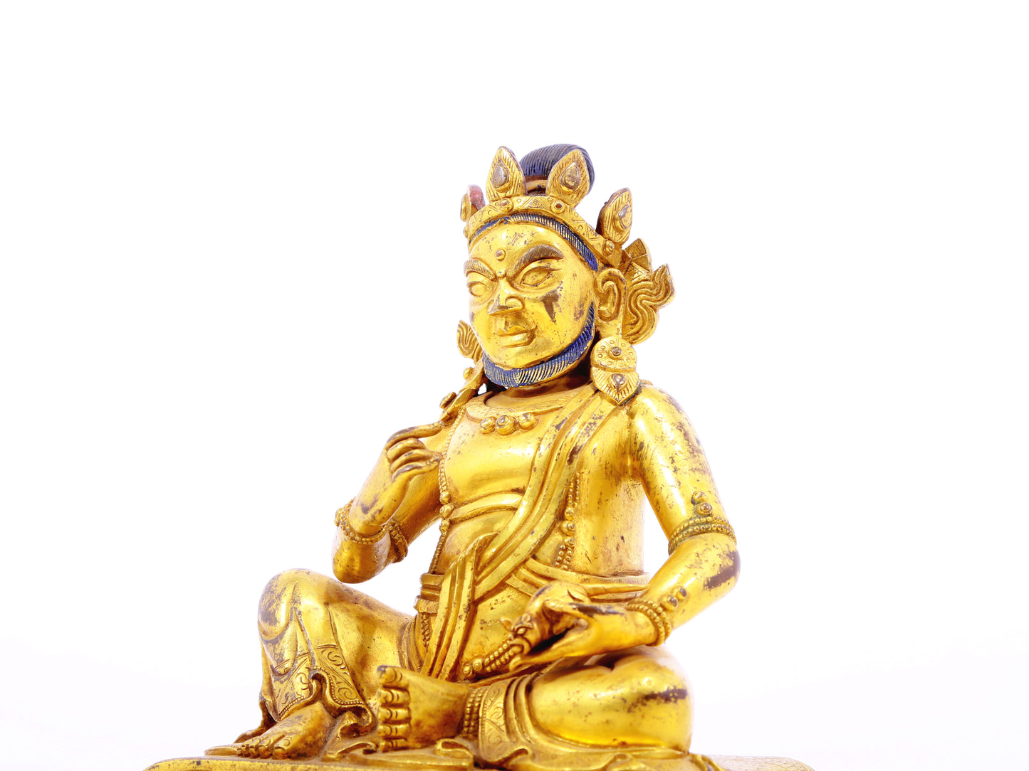 A serene gilt bronze statue of the God of Wealth