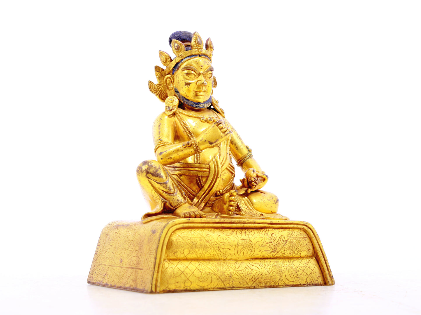 A serene gilt bronze statue of the God of Wealth