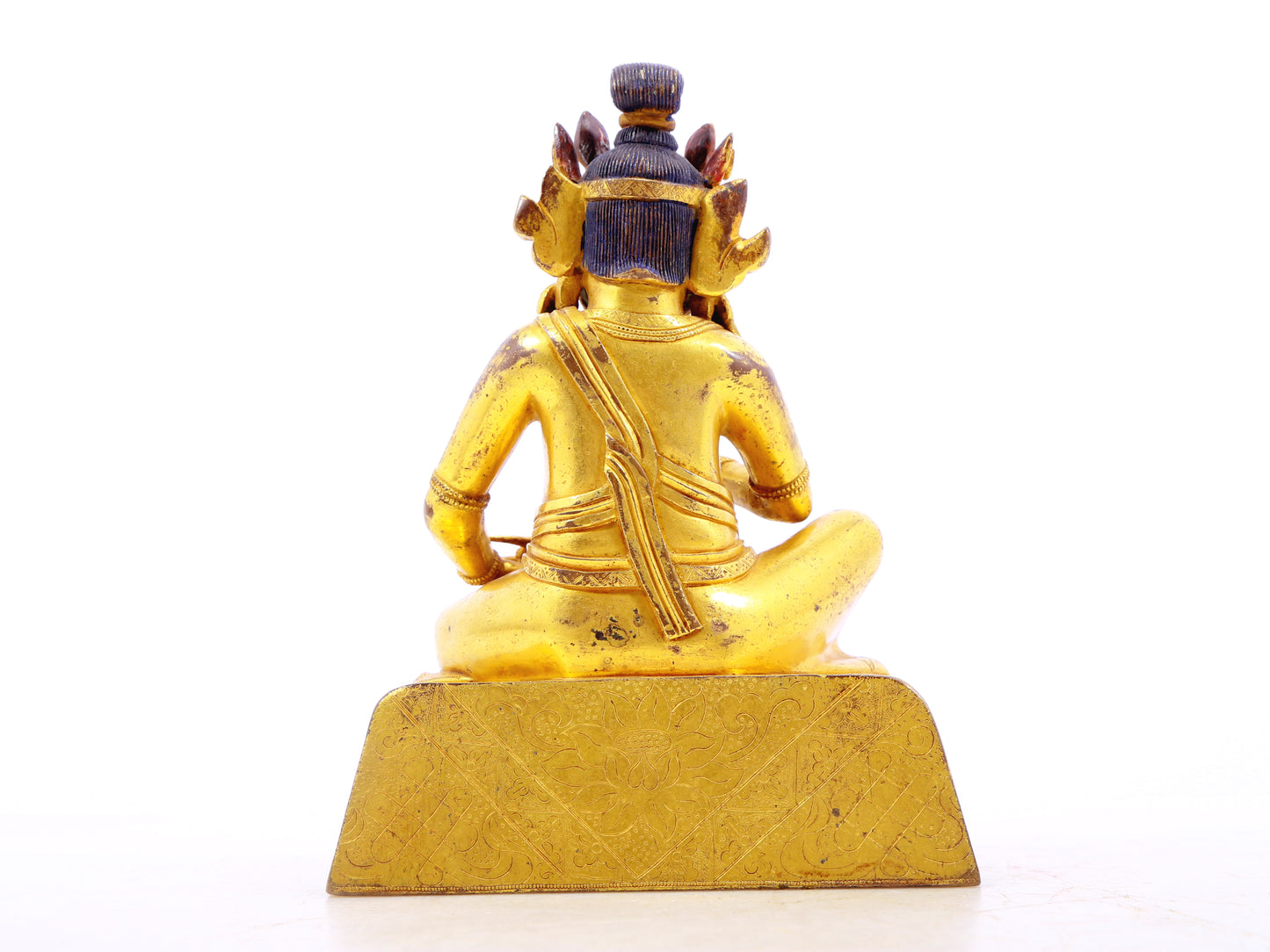 A serene gilt bronze statue of the God of Wealth