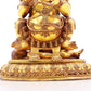 A serene gilt bronze statue of the God of Wealth