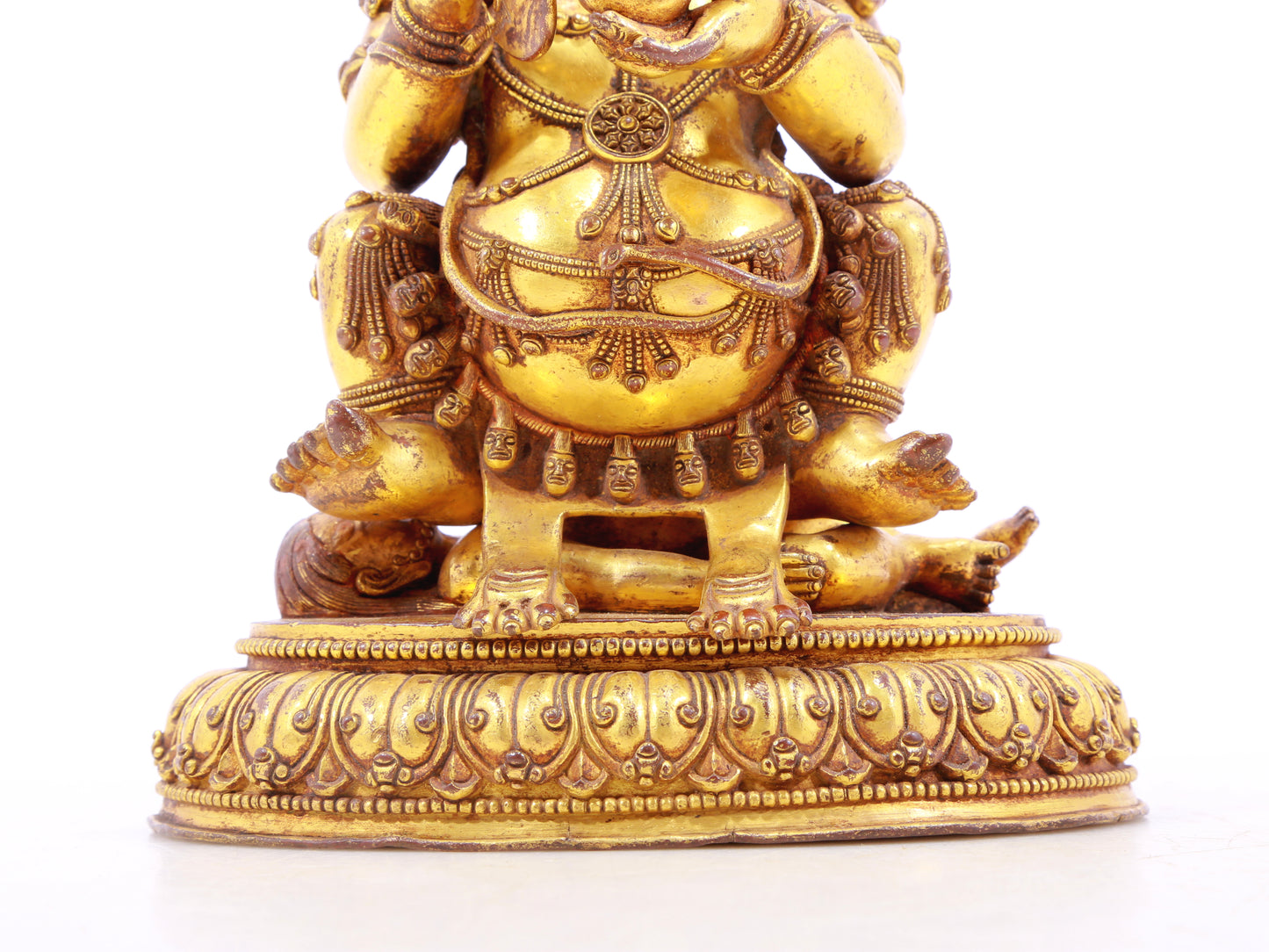 A serene gilt bronze statue of the God of Wealth