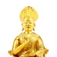 A serene gilt bronze statue of the guru