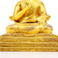 A serene gilt bronze statue of the guru