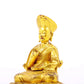 A serene gilt bronze statue of the guru