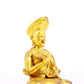 A serene gilt bronze statue of the guru