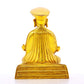 A serene gilt bronze statue of the guru