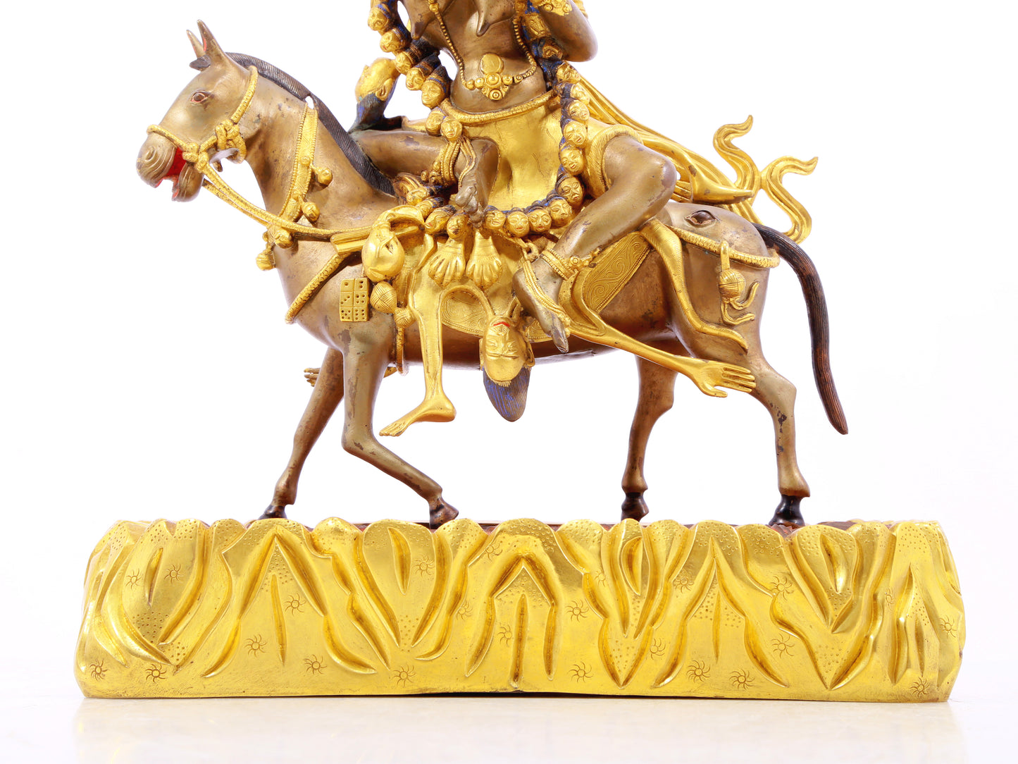 A serene gilt bronze equestrian statue of the God of Wealth