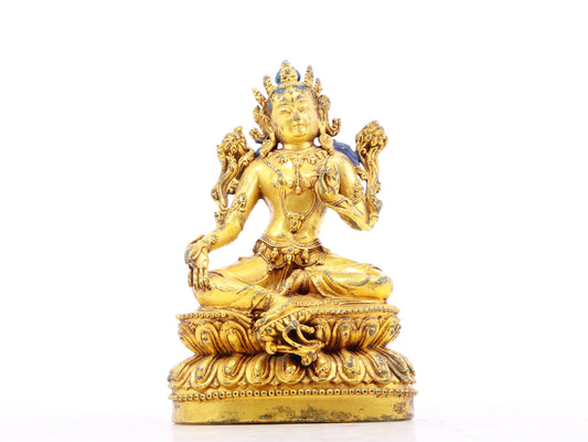 A serene gilt bronze statue of green Tara