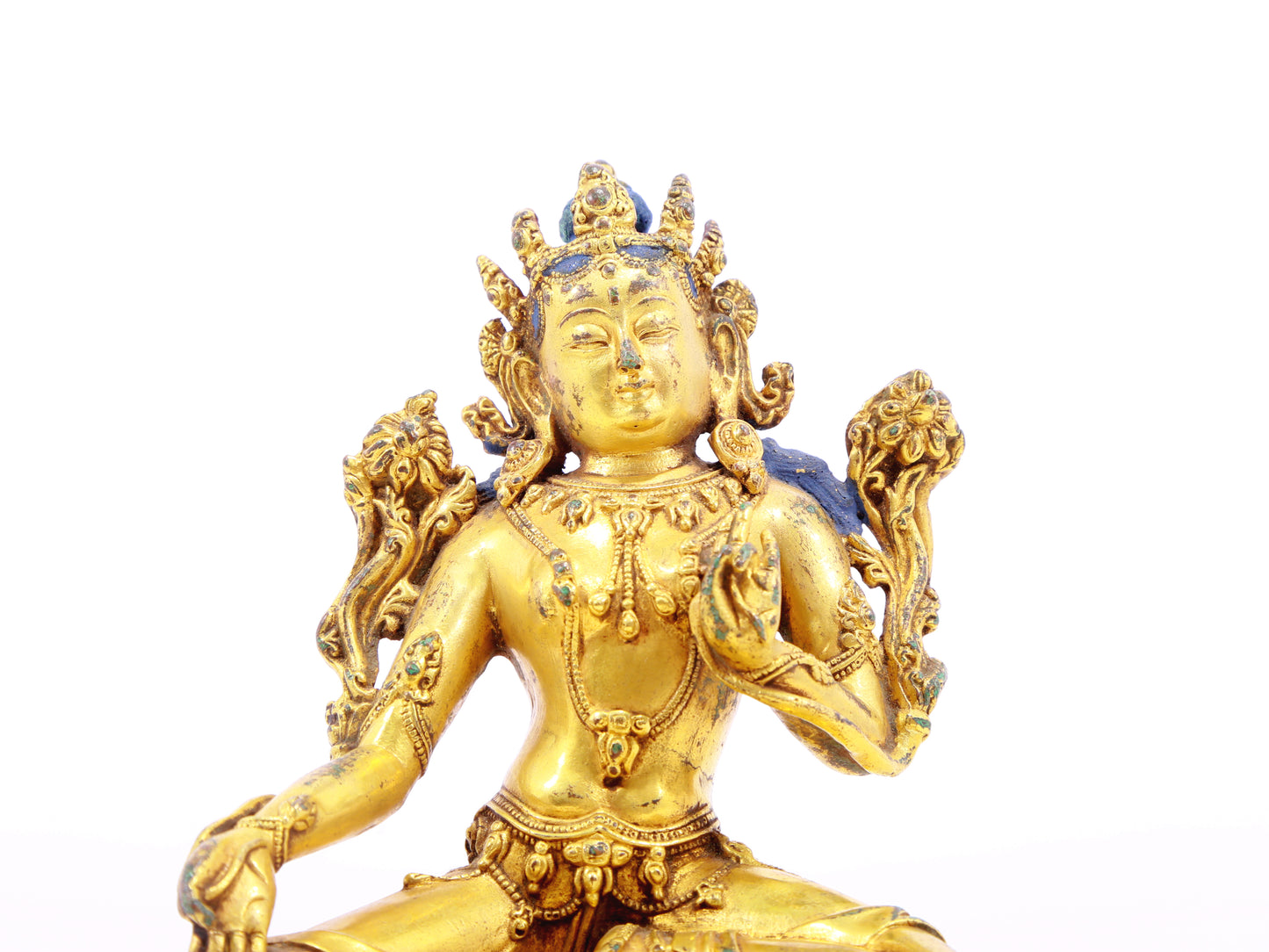 A serene gilt bronze statue of green Tara