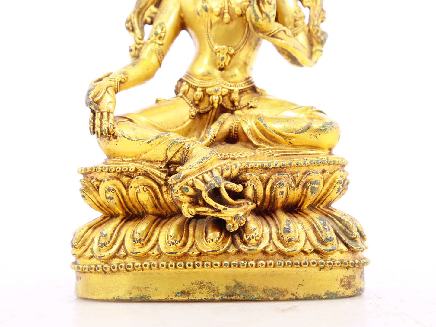 A serene gilt bronze statue of green Tara