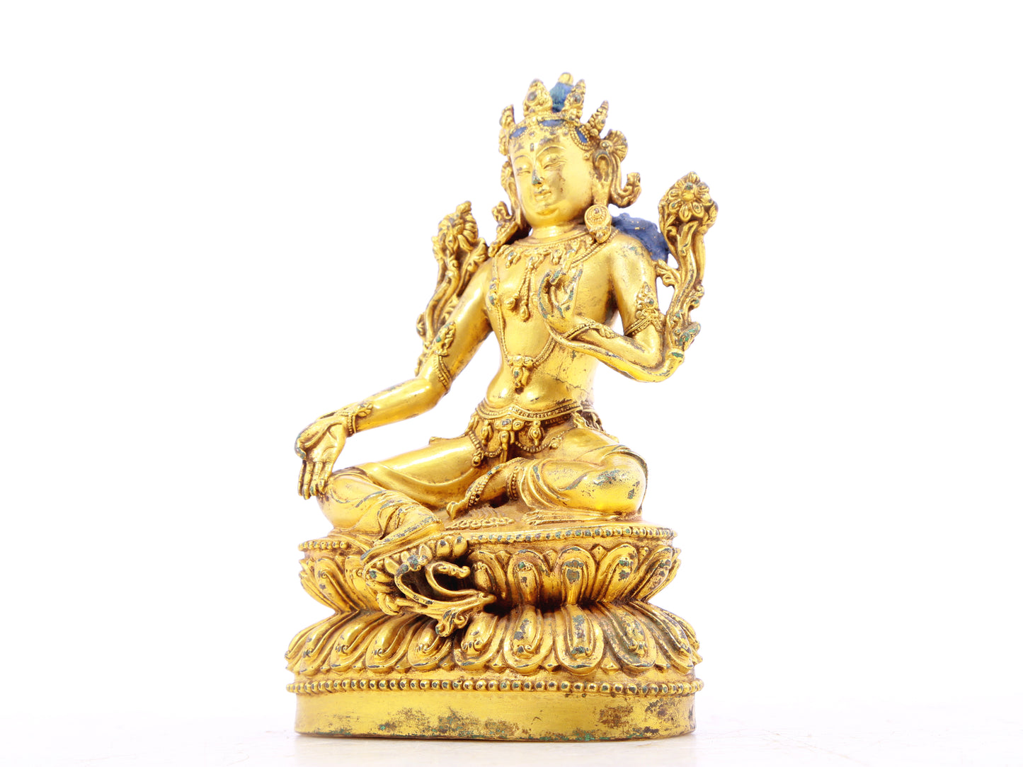 A serene gilt bronze statue of green Tara